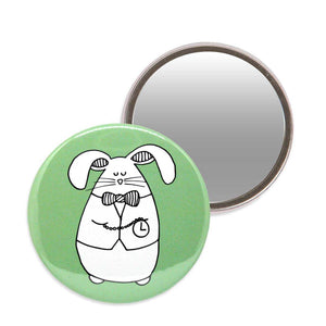 Green makeup mirror with an illustration of a white rabbit