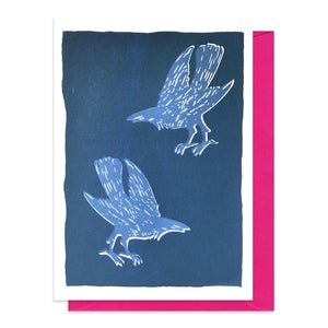 Blue card with a design featuring two screen printed crows