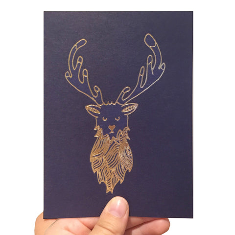 Navy blue card with a gold foil stag illustration