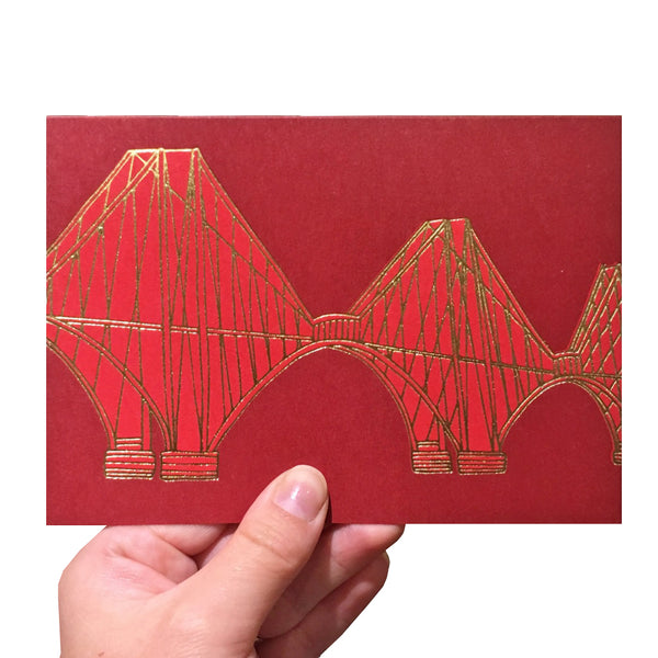 Red greeting card with a gold foiled illustration of the Forth Rail Bridge