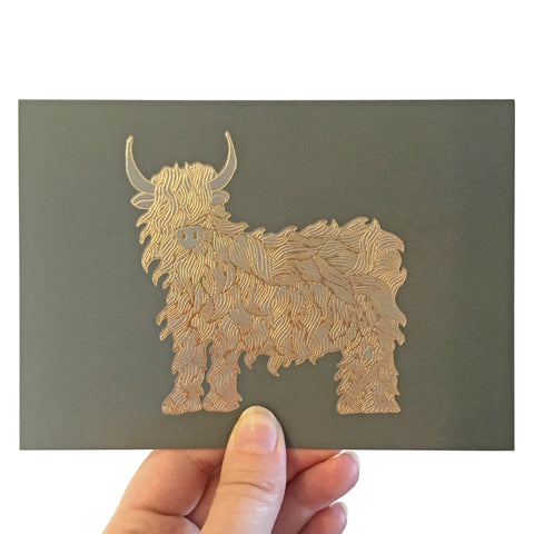 Image of card featuring a beautiful gold foiled highland cow