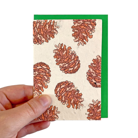 Seed paper card with a pine cone pattern