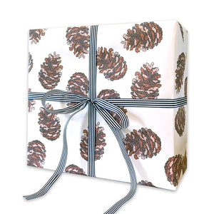 White wrapping paper with a pine cone pattern