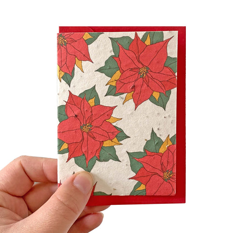 Seed paper card with a poinsettia pattern