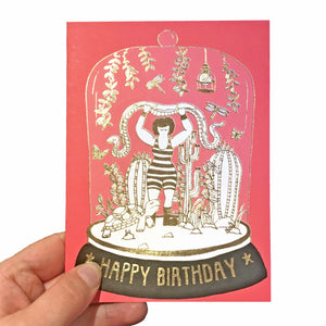 Pink birthday card featuring a strong woman holding a snake