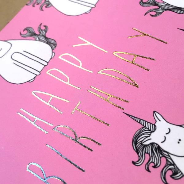 Close up of gold foil on pink unicorn birthday card