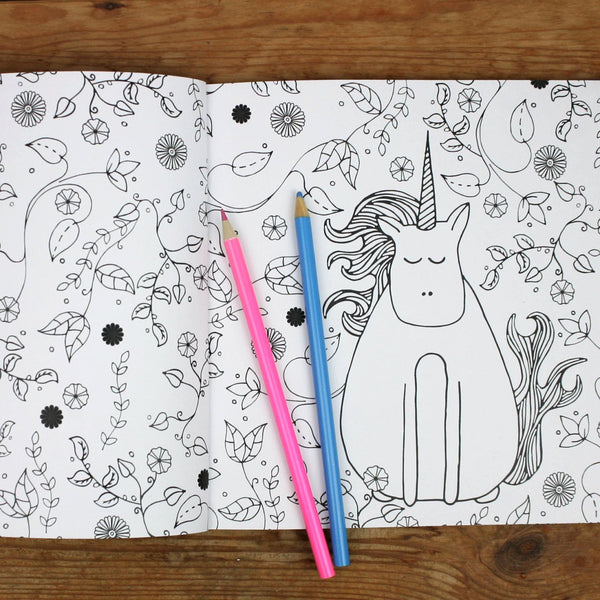 A page from A-Z of Unicorn Colouring Book featuring a unicorn in a garden 